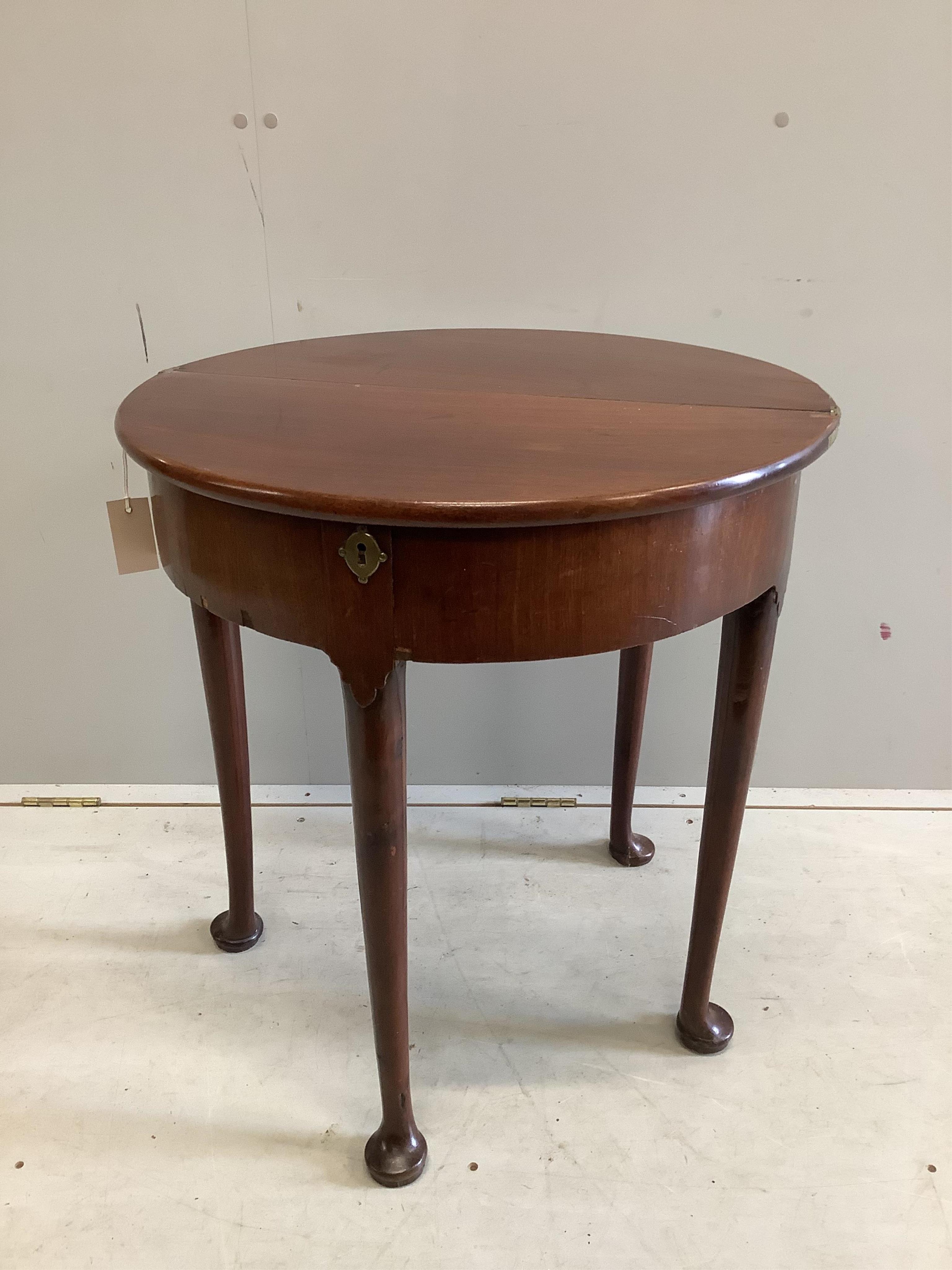 A small George II and later demi lune folding mahogany tea table, width 64cm, depth 32cm, height 70cm. Condition - fair